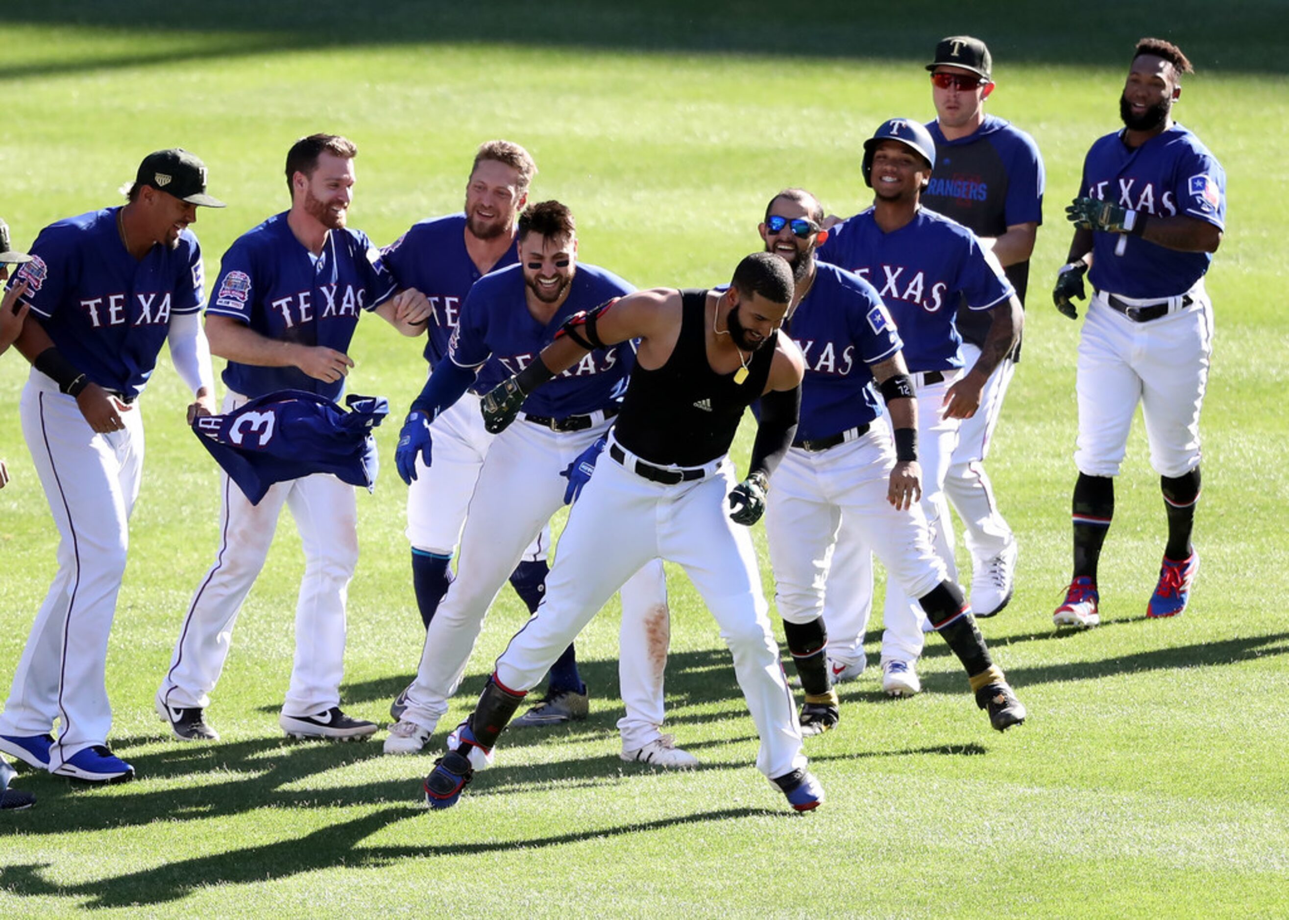 ARLINGTON, TEXAS - MAY 19:  The Texas Rangers celebrate the game winning run scored on a...