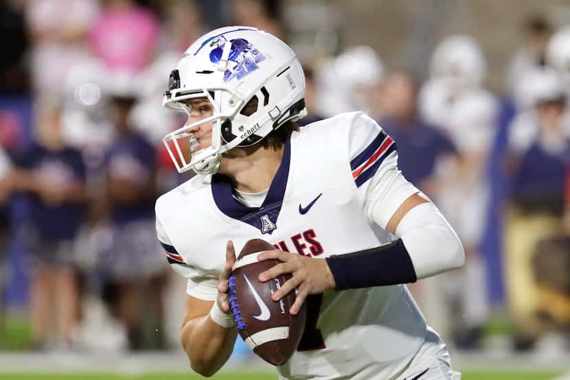 Allen High School quarterback Brady Bricker (7) looks for a passing option during the first...