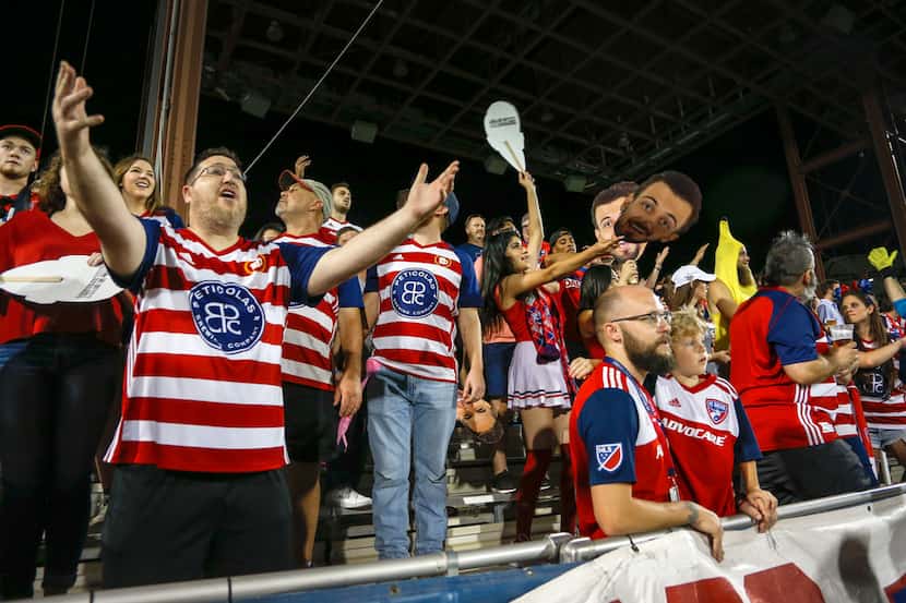 People in the FC Dallas section react to a play during the soccer game between FC Dallas and...