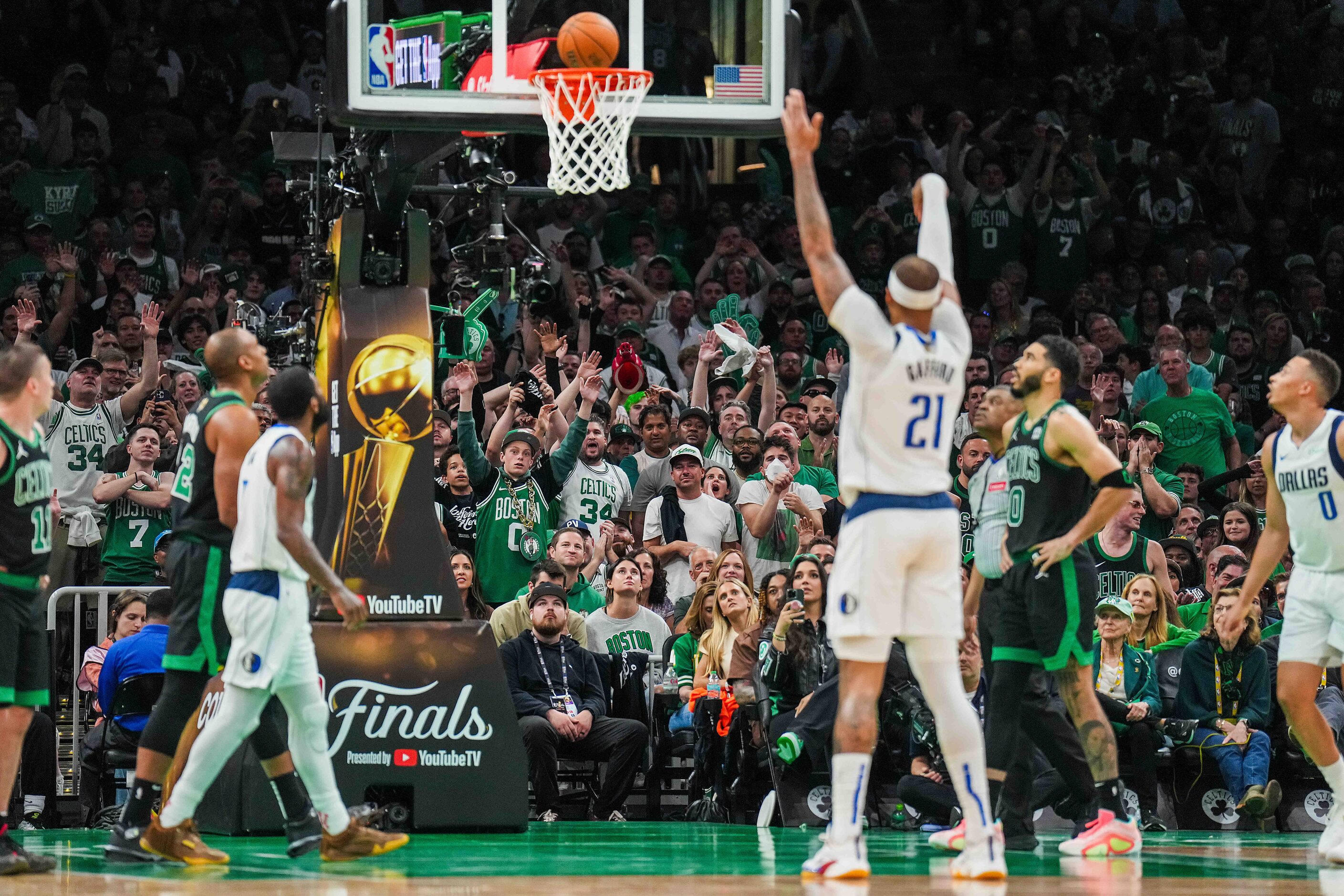 Boston Celtics fans cheer as Dallas Mavericks center Daniel Gafford (21) misses a free throw...