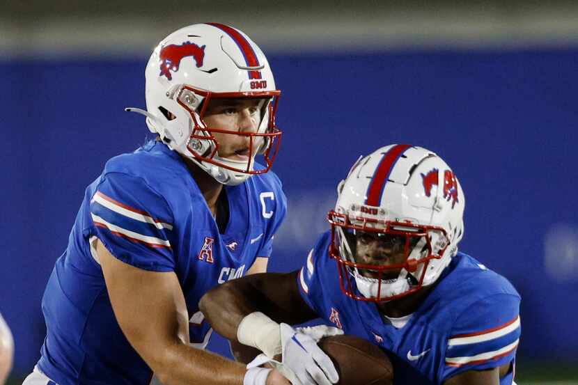 SMU quarterback Preston Stone (2), left, hands off to SMU running back Velton Gardner (24)...