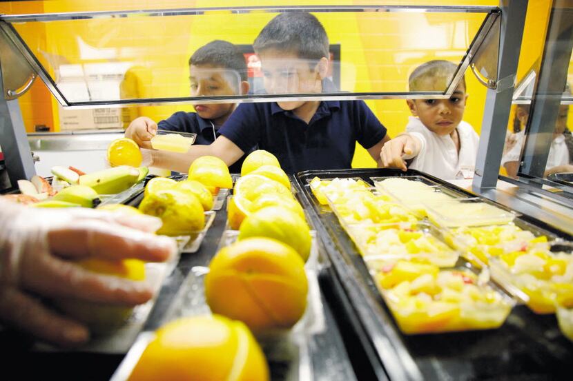 Students at Central Elementary school in Lewisville pick a fruit from the cafeteria line ...