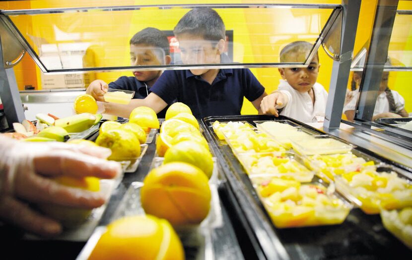 Students at Central Elementary school in Lewisville pick a fruit from the cafeteria line ...