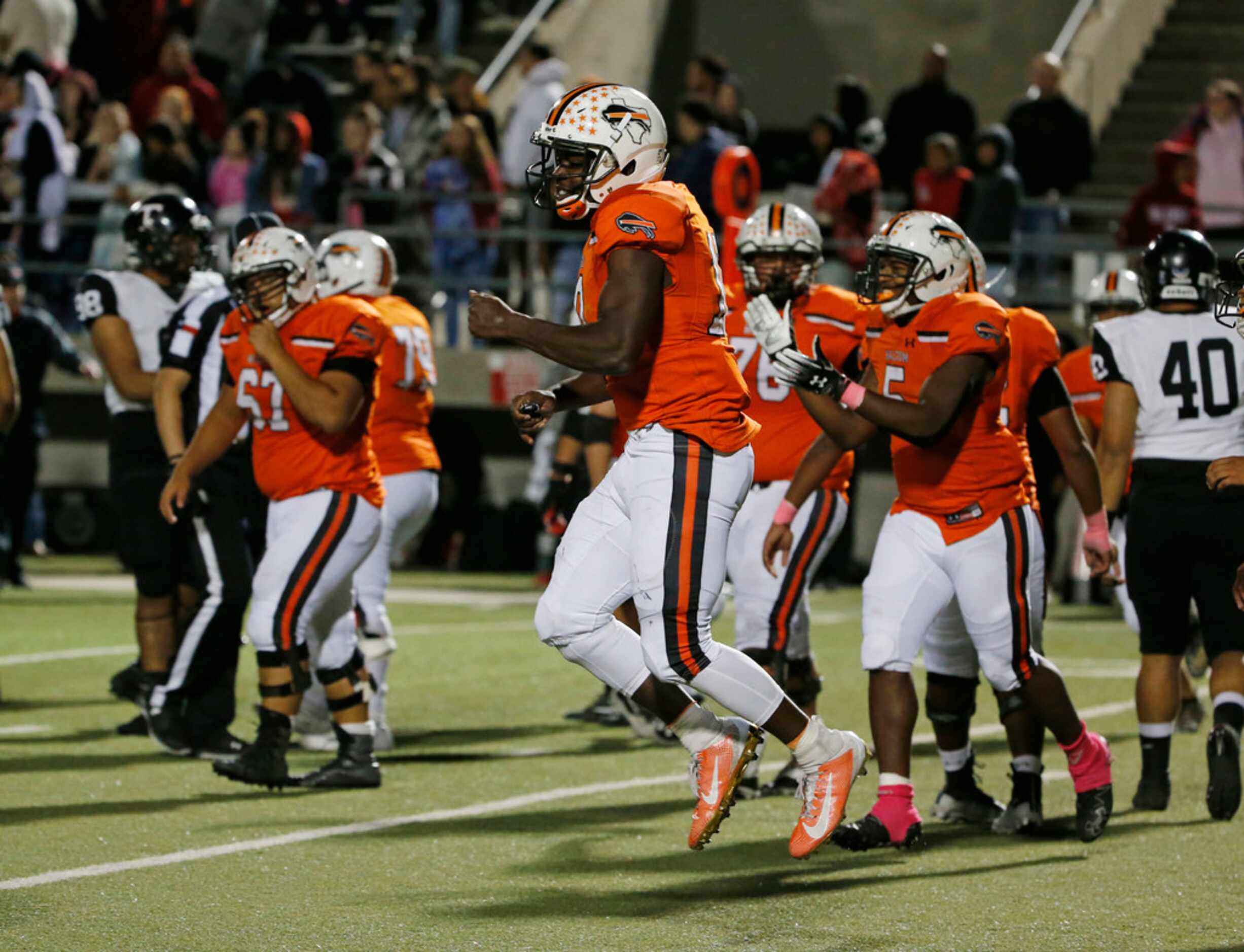 Haltom quarterback Adam Hill (10) celebrates at they defeated Euless Trinity during their...