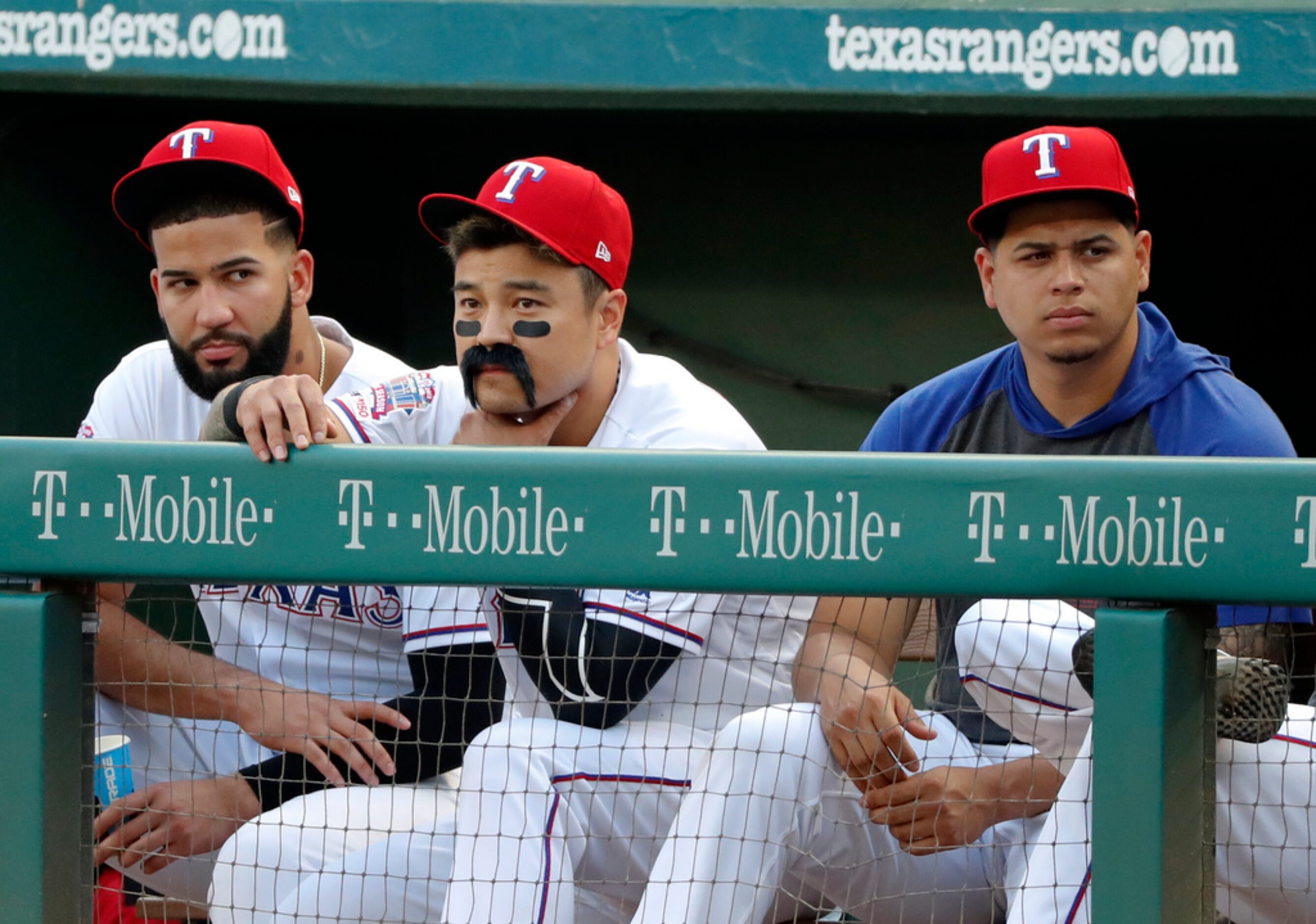 Texas Rangers' Nomar Mazara, left, and Ariel Jurado, right, sit beside Shin-Soo Choo,...