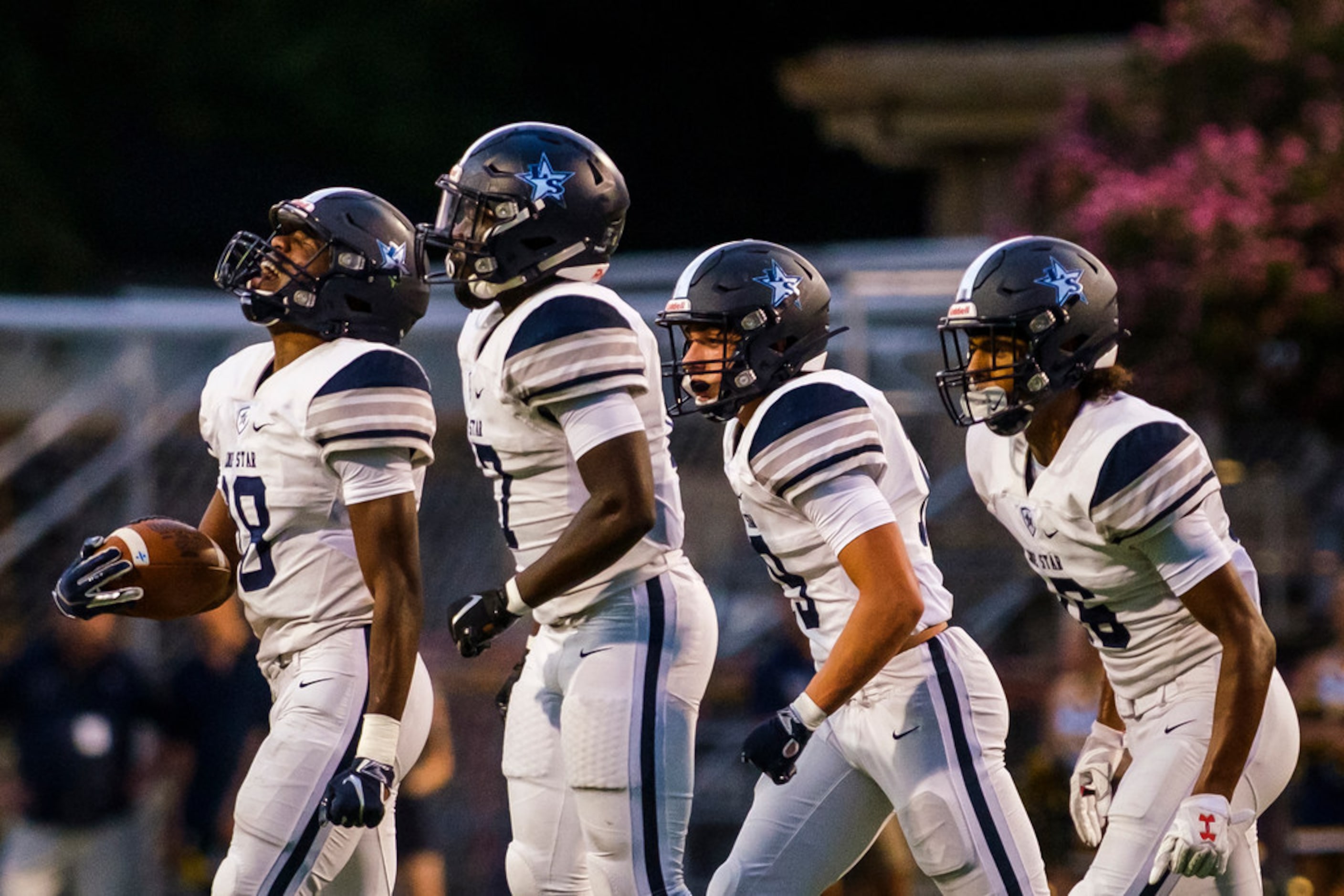 Frisco Lone Star wide receiver Marvin Mims (18) celebrates with teammatesafter a long...