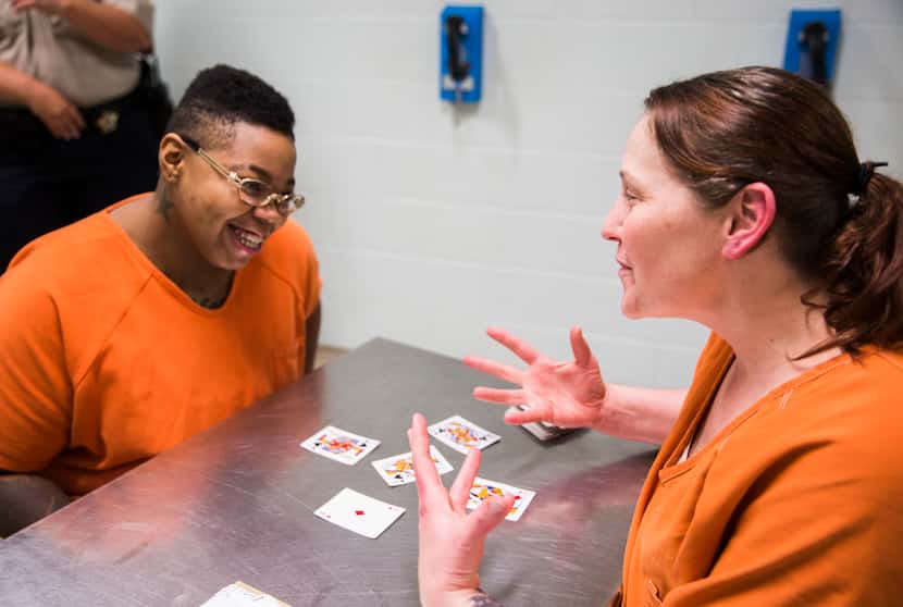 Inmates Sheniqua Miller, 23, (left) and Stacy Jensen, 38, play cards in their unit at the...