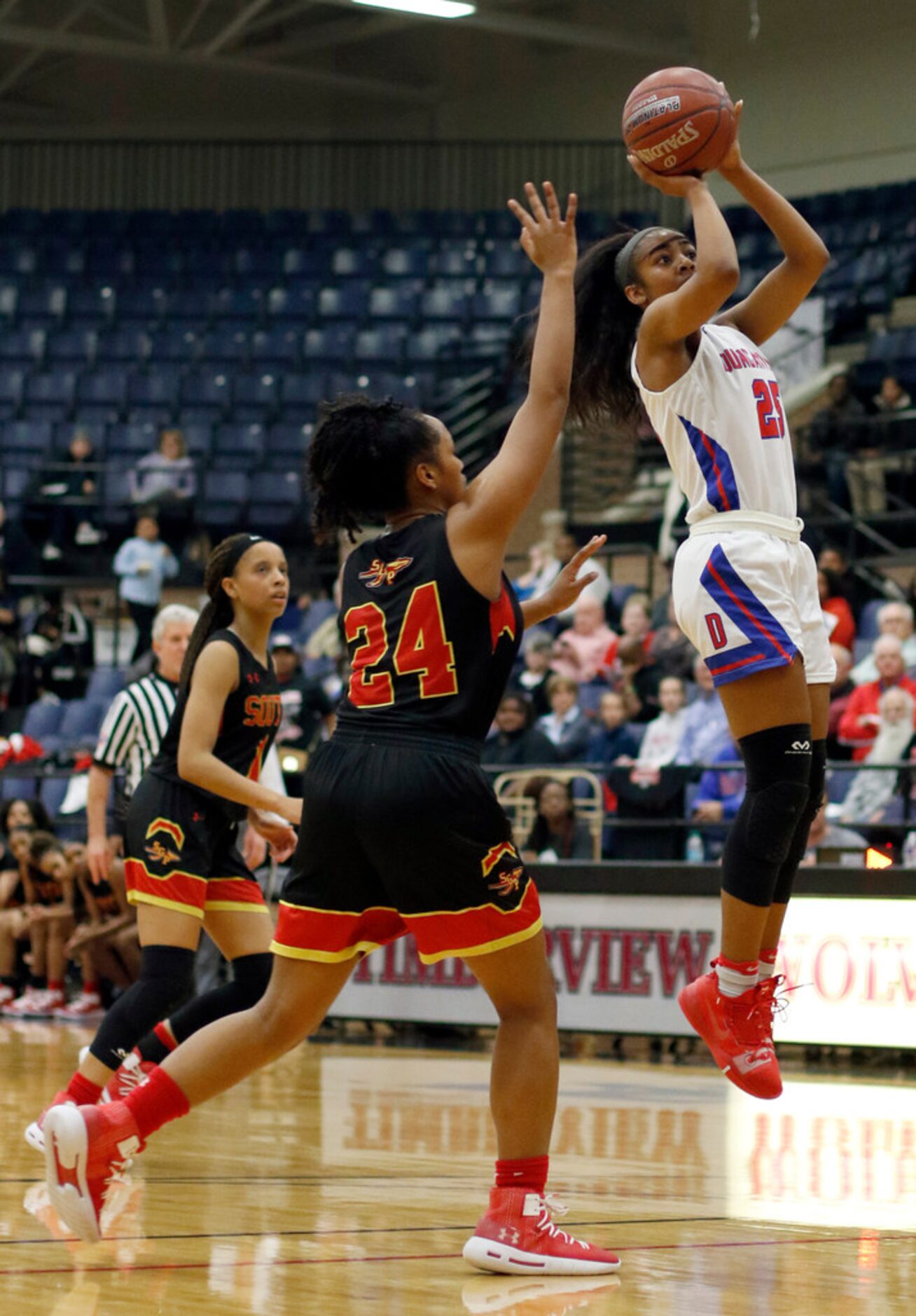 Duncanville guard Deja Kelly (25) shoots a jump shot as South Grand Prairie defenders...