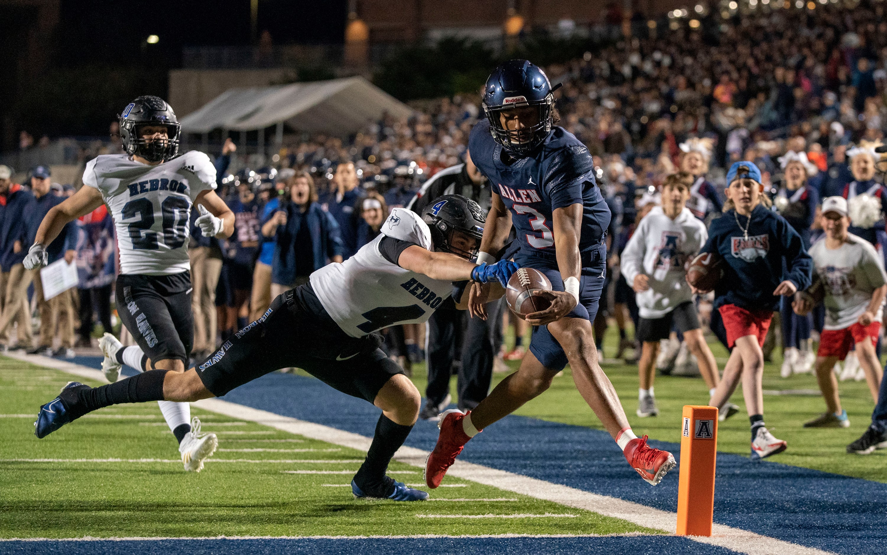 Allen sophomore quarterback Mike Hawkins (3) reaches for the pylon as Hebron safety Matthew...