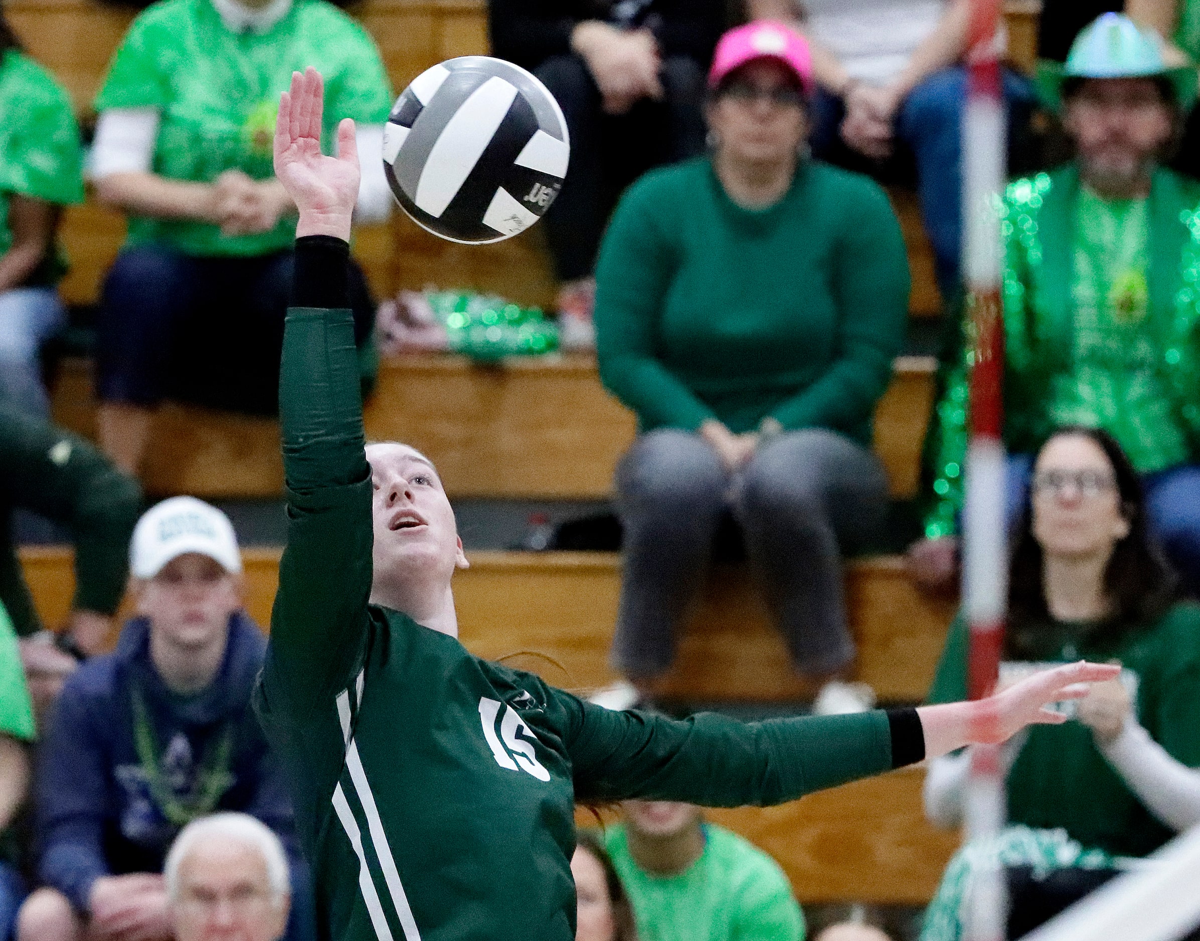 Hockaday middle blocker Olivia Wayne (15) hits the ball over the net during game one as...