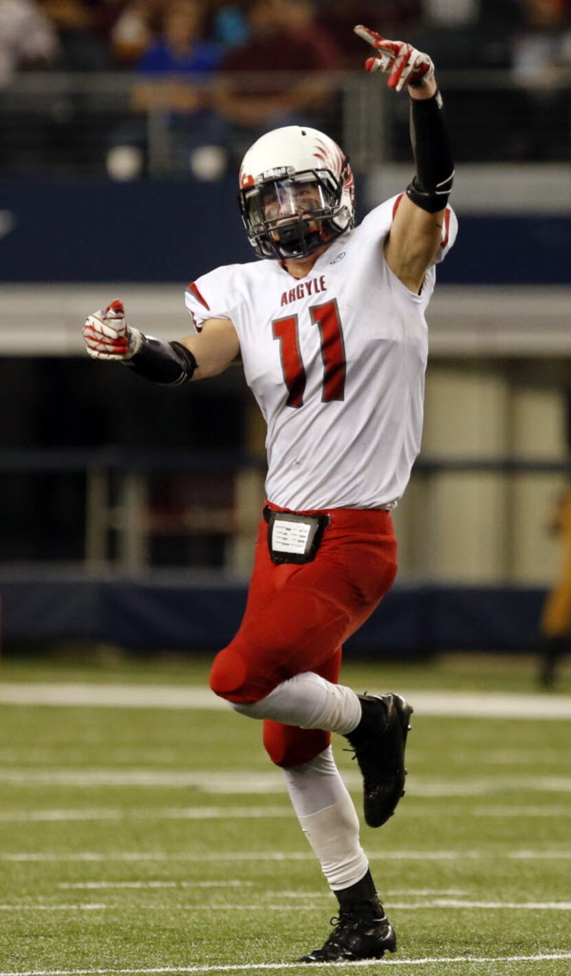 Argyle High's Conner Wilson (11) celebrates, after catching an interception during the first...