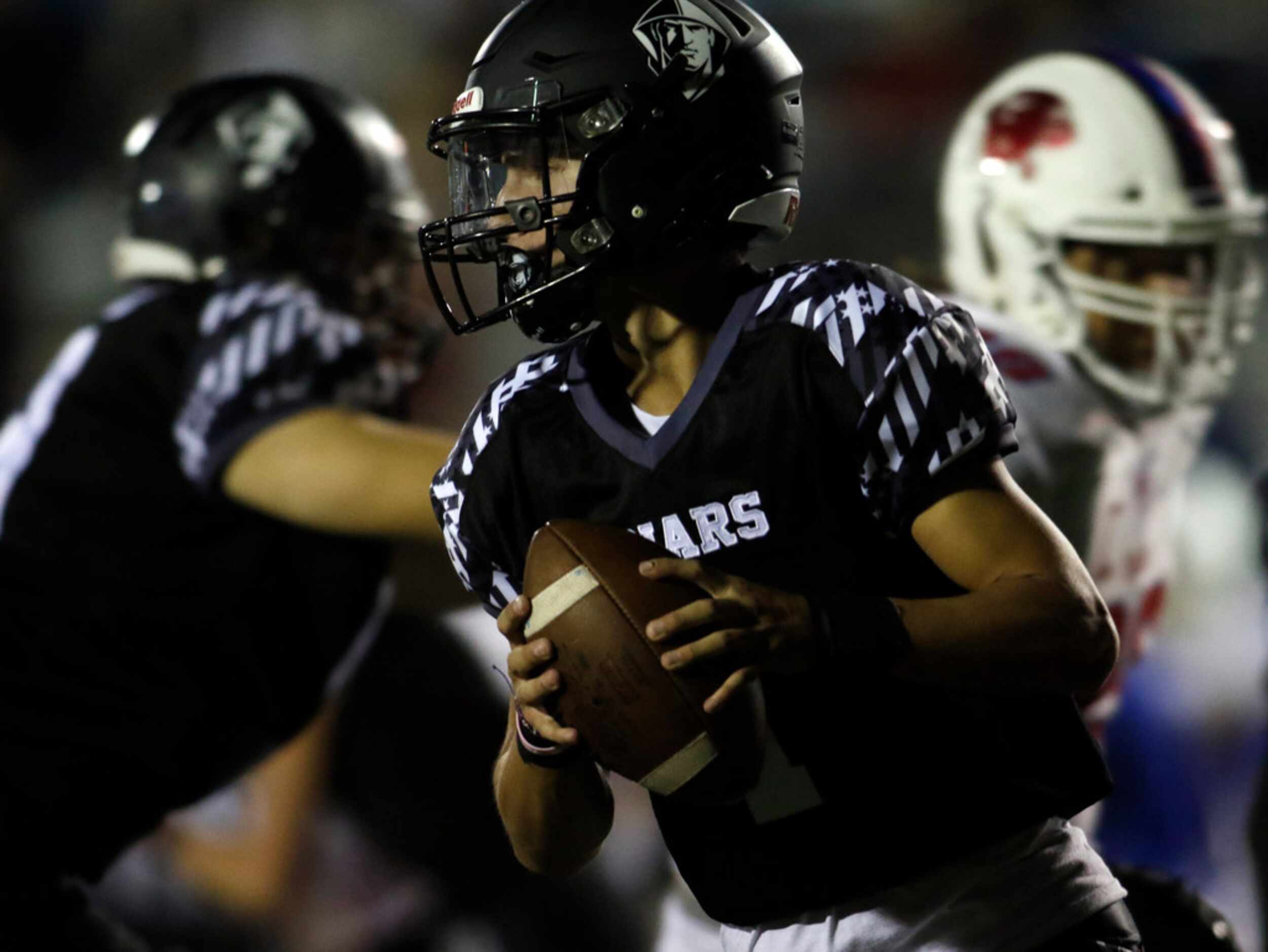 Bishop Lynch quarterback Michael Light (1) rolls out of the pocket in search of a receiver...