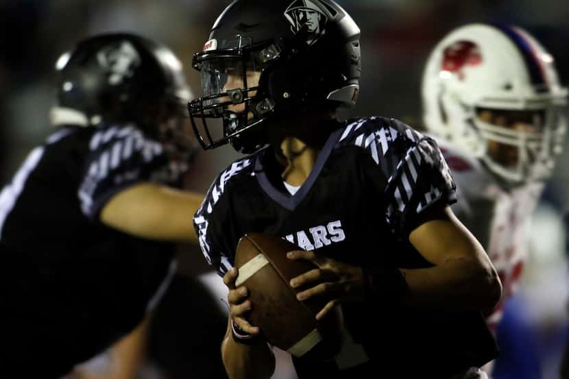 Bishop Lynch quarterback Michael Light (1) rolls out of the pocket in search of a receiver...