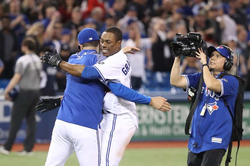 TORONTO, ON - APRIL 24: Curtis Granderson #18 of the Toronto Blue Jays is congratulated by...