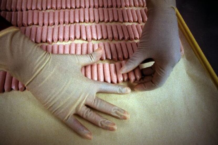 In this 1998 file photo, lipstick is placed in rows on a tray after coming out of a metal...