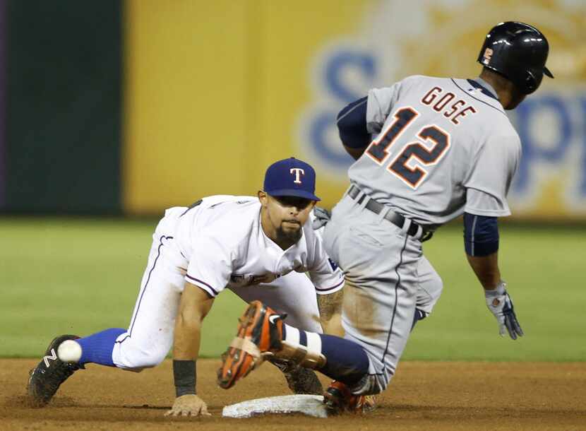 Texas Rangers second baseman Rougned Odor (12) can't make the play at second base after...