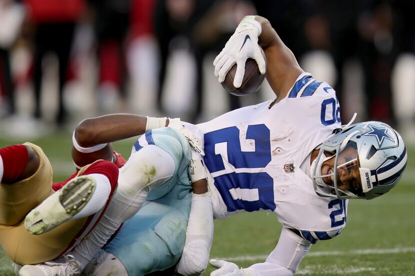 Dallas Cowboys running back Tony Pollard (20) is tackled by San Francisco 49ers cornerback...