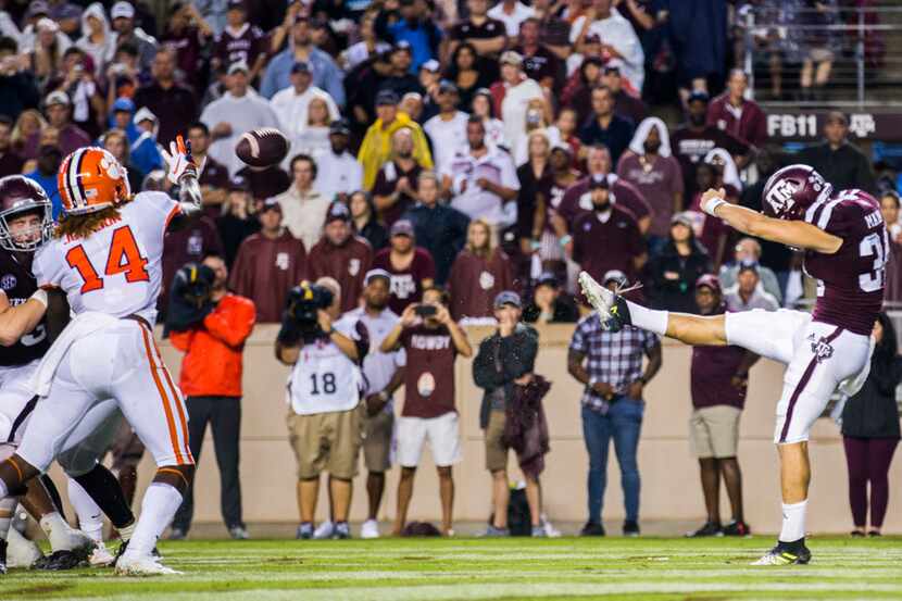 Texas A&M Aggies punter Braden Mann (34) punts the ball at the end of the second quarter...