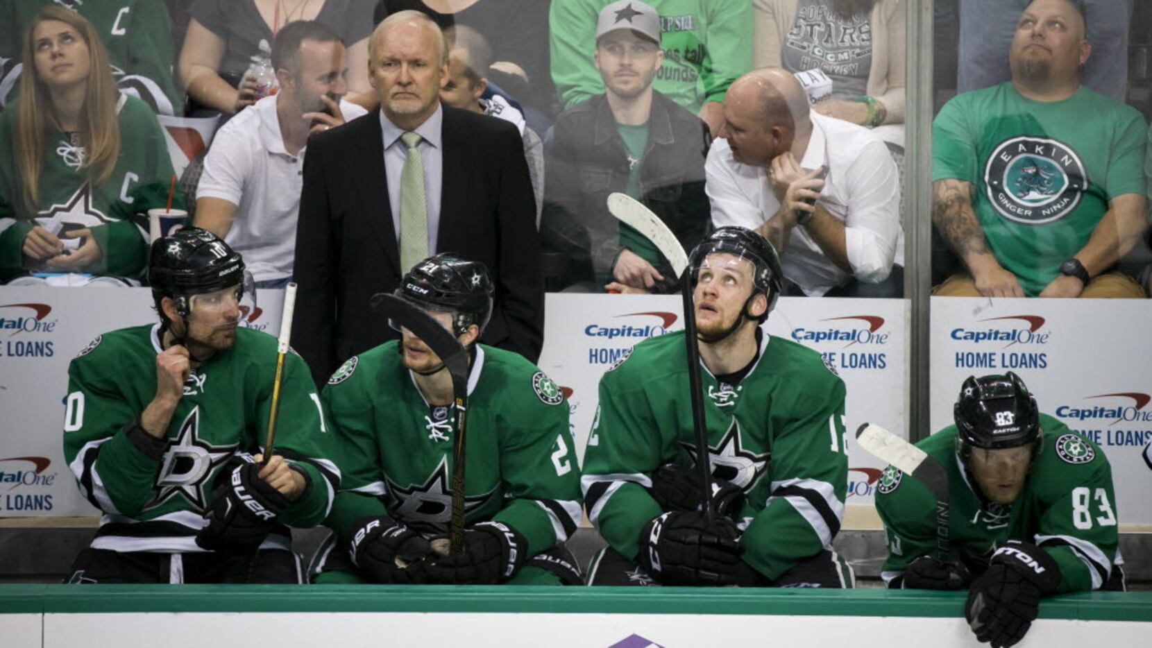 Dallas Stars head coach Lindy Ruff stands over a somber bench during the third period of a...