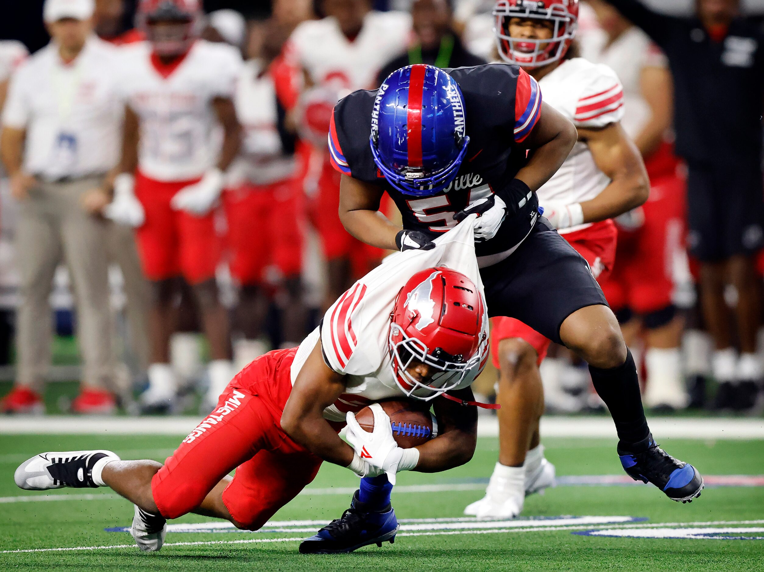 Duncanville offensive lineman Jerry Scales (54) drags Galena Park North Shore defensive back...