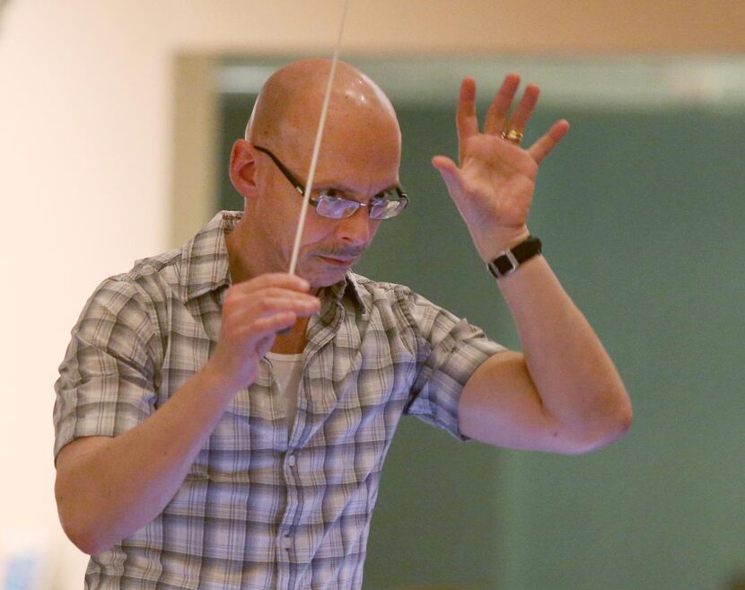 
Conductor Jay Dias practices during a rehearsal of The New Moon, presented by Lyric Stage...