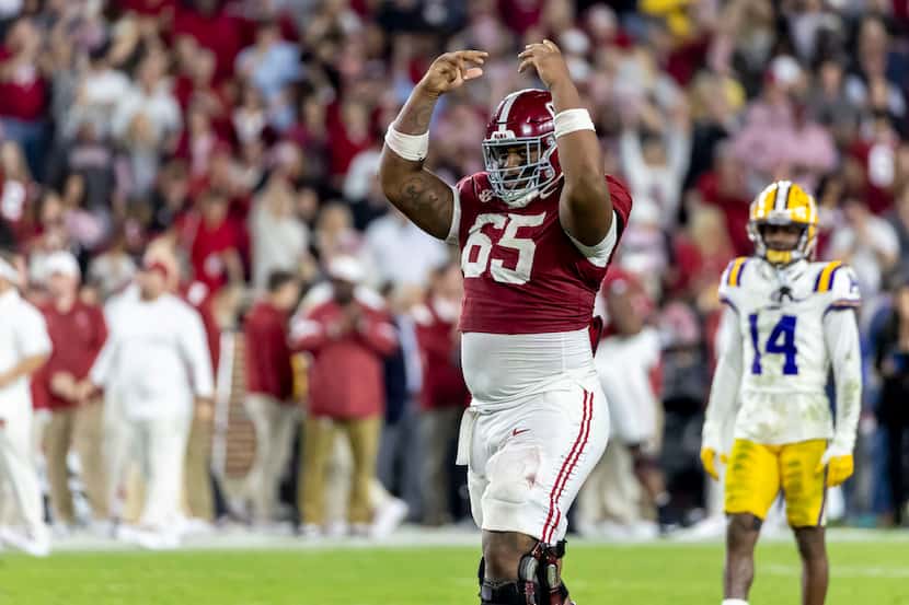 Alabama offensive lineman JC Latham (65) cheers the student section in the final minute of...