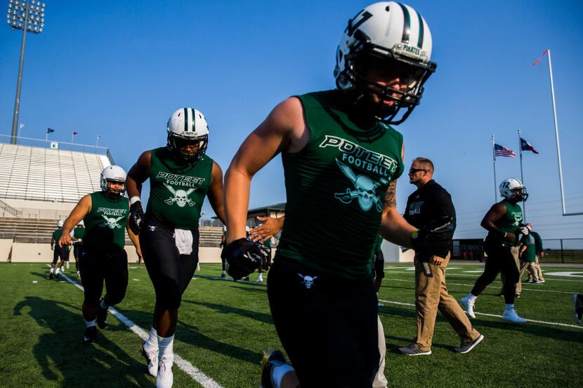 Mesquite Poteet football players warms up during a high school football game between...