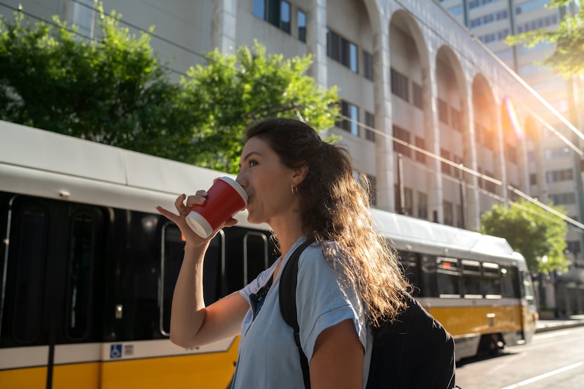 Courtney Lynn Hunter waits for the DART train in downtown Dallas, as part of her regular...