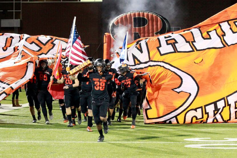 The Rockwall team breaks through their banner, as they take the field before the first half...