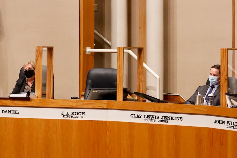 Dallas County Judge Clay Jenkins (right) and County Commissioner Theresa Daniel sit next to...