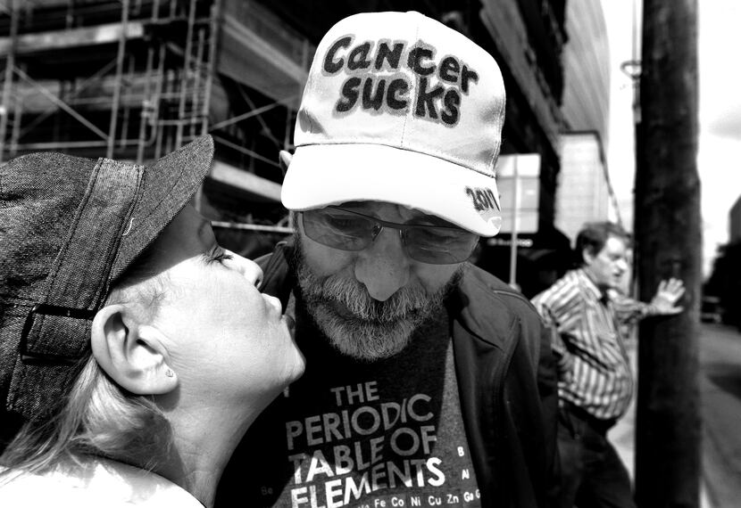 Weiss gets a kiss from his Marni as they wait to cross the street near the hospital. (Louis...