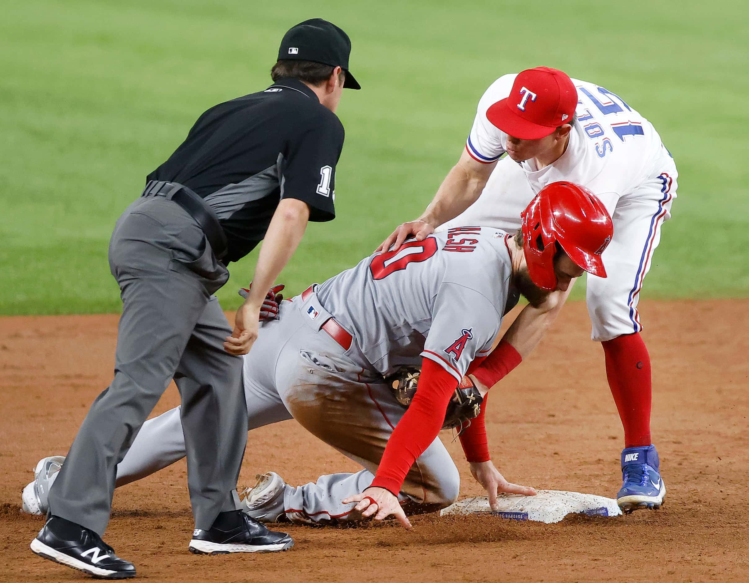 233Texas Rangers second baseman Nick Solak (15) tagged out Los Angeles Angels Jared Walsh...