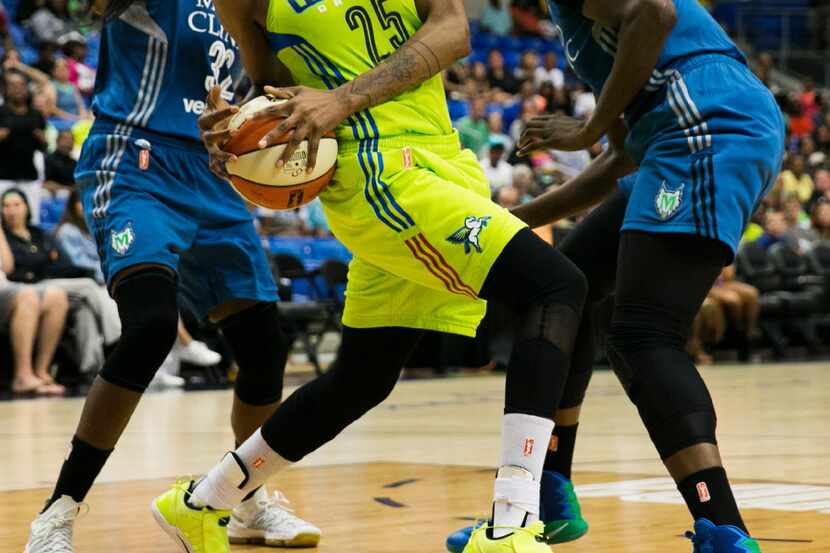 Dallas Wings forward Glory Johnson (25) fights for a loose ball against Minnesota Lynx...