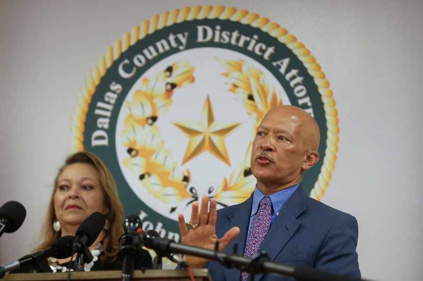Dallas County District Attorney John Creuzot, right, speaks as the offices of the Dallas...