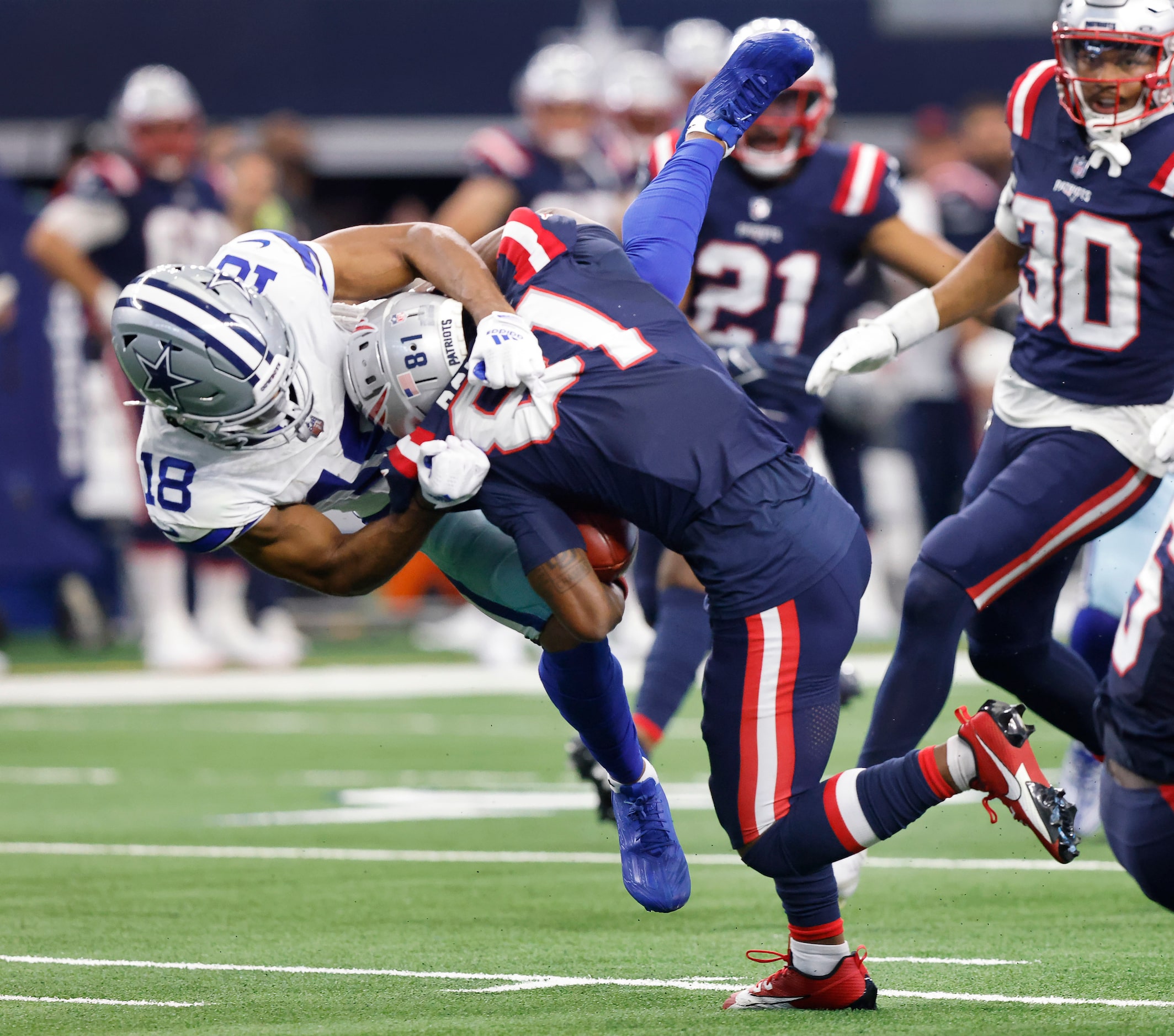 Dallas Cowboys wide receiver Jalen Tolbert (18) makes a flying tackle of New England...