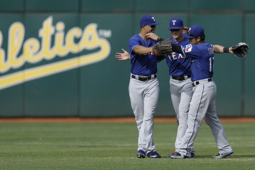 Texas Rangers outfielders Will Venable, left, and Shin-Soo Choo, right, celebrate the 8-1...