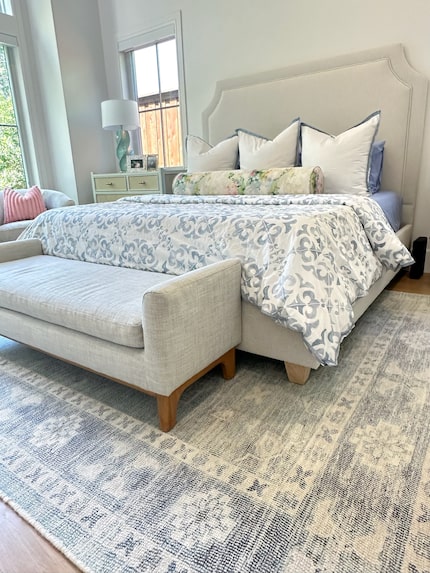 A rug in a bedroom, like this one from Joss & Main, adds warmth to a space with lots of...