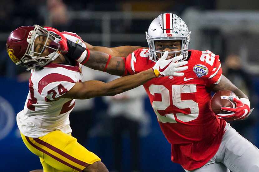 Ohio State running back Mike Weber (25) pushes away from USC cornerback Isaiah Langley (24),...