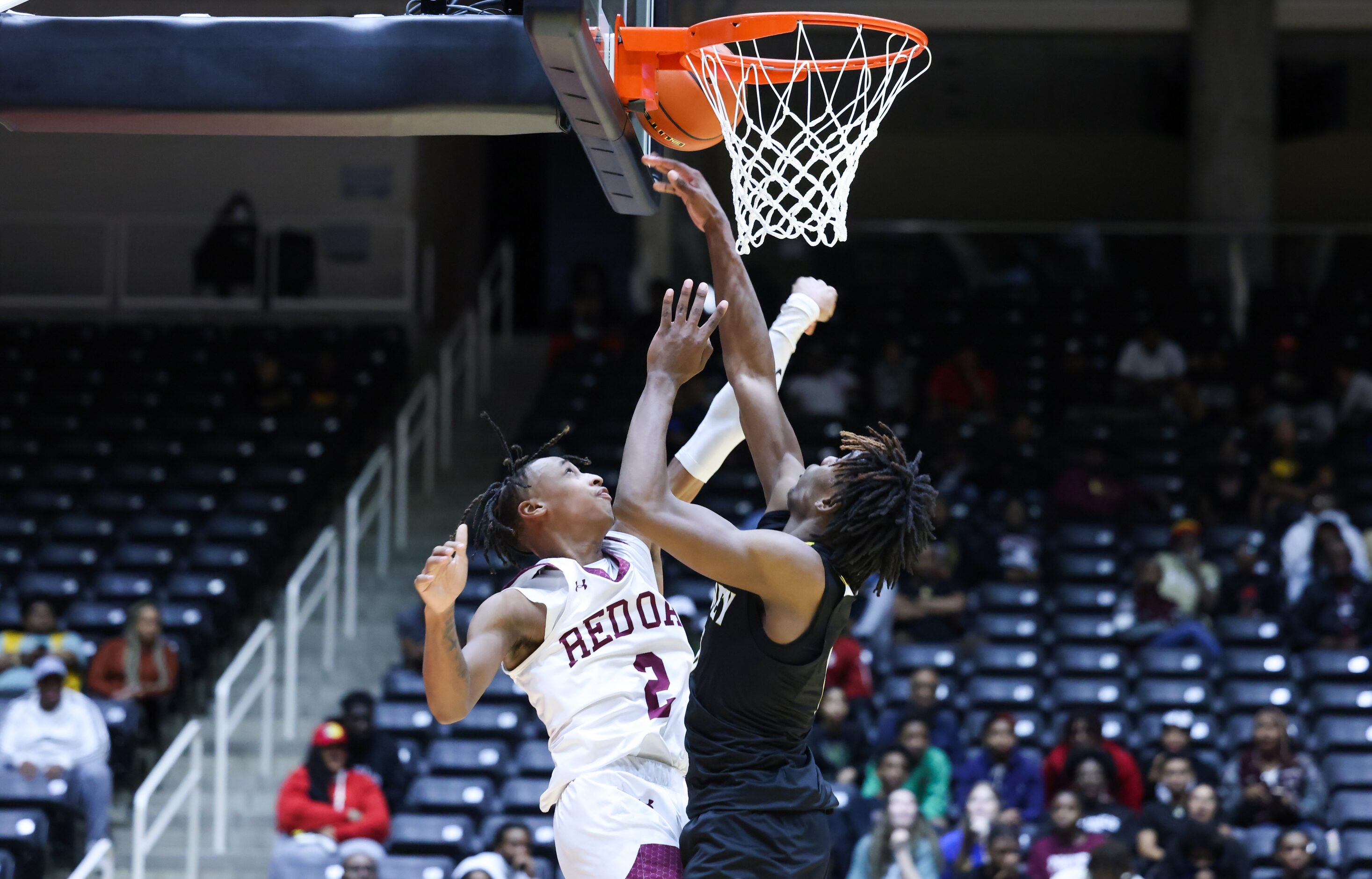 Red Oak senior guard Jayden Murphy (2) and Forney senior forward Ronnie Harrison (0, right)...