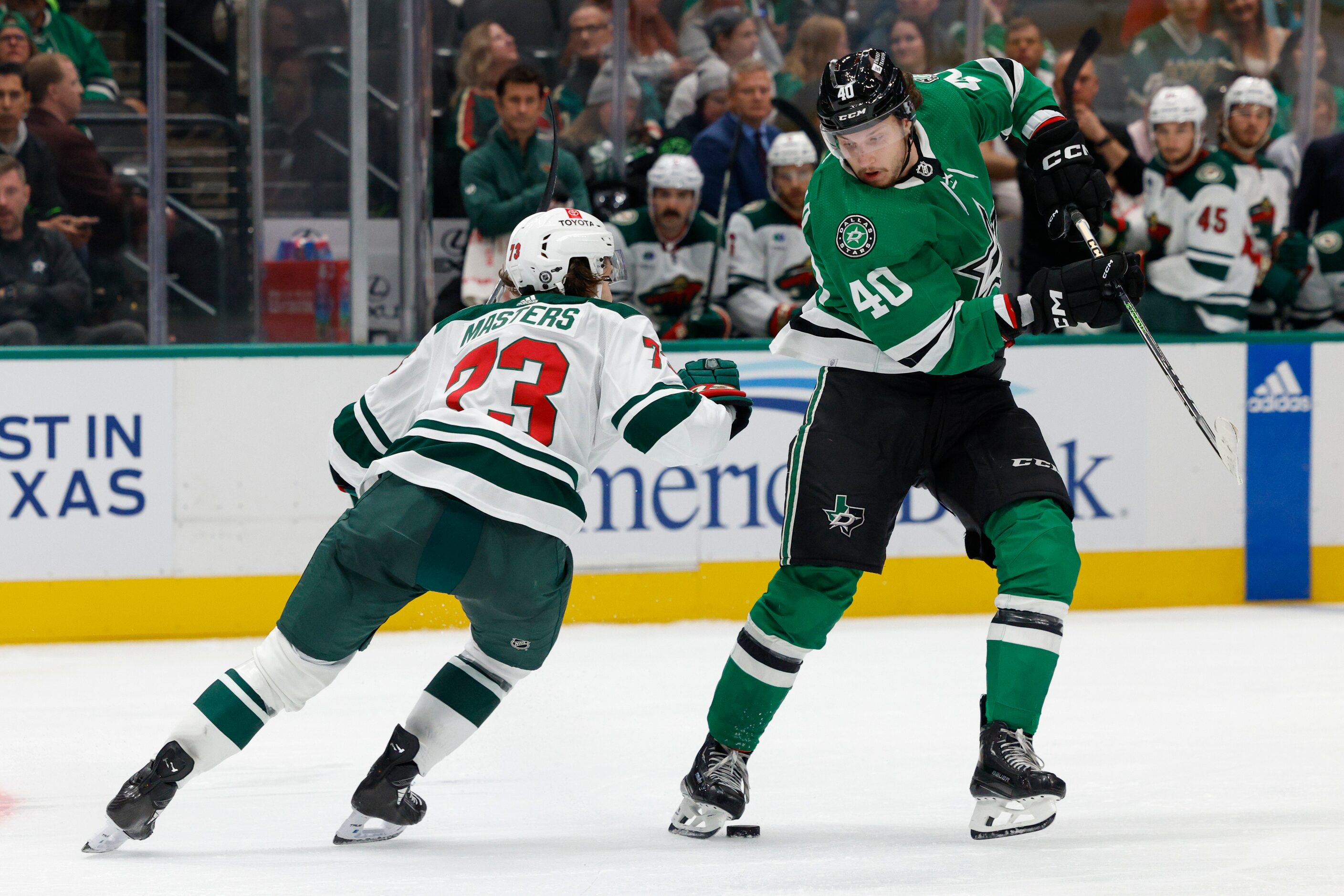 Dallas Stars right wing Kyle McDonald (40) skates around Minnesota Wild center Marco Rossi...