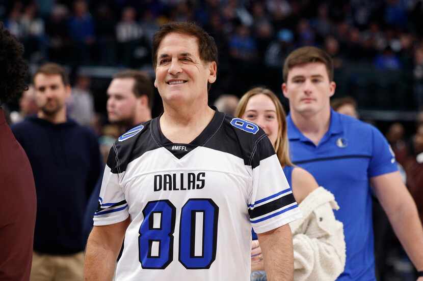 Dallas Mavericks minority stakeholder Mark Cuban smiles as he walks off the court after the...
