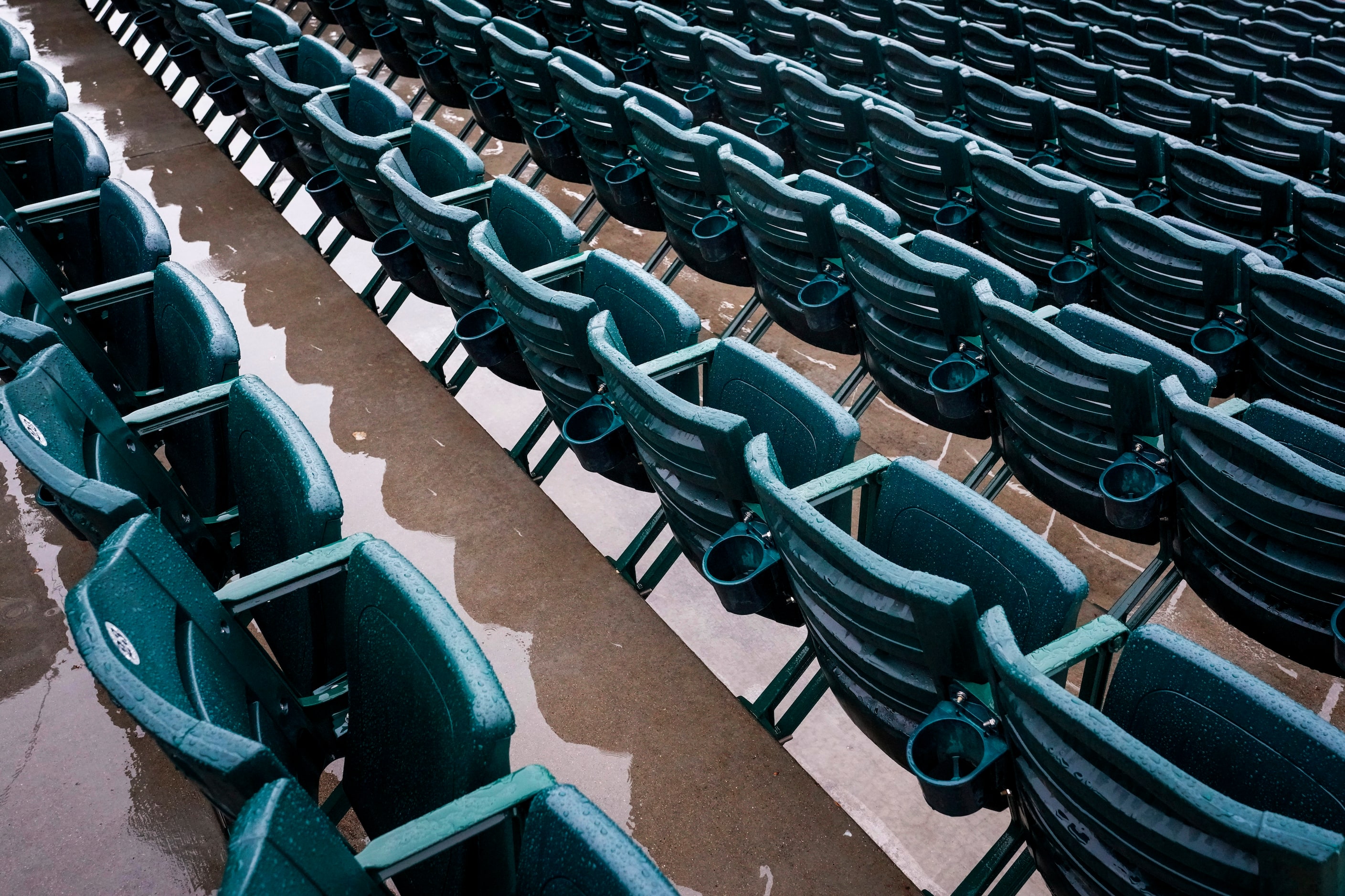 Rain puddles around empty seats at Surprise Stadium on Saturday, Feb. 22, 2020, in Surprise,...