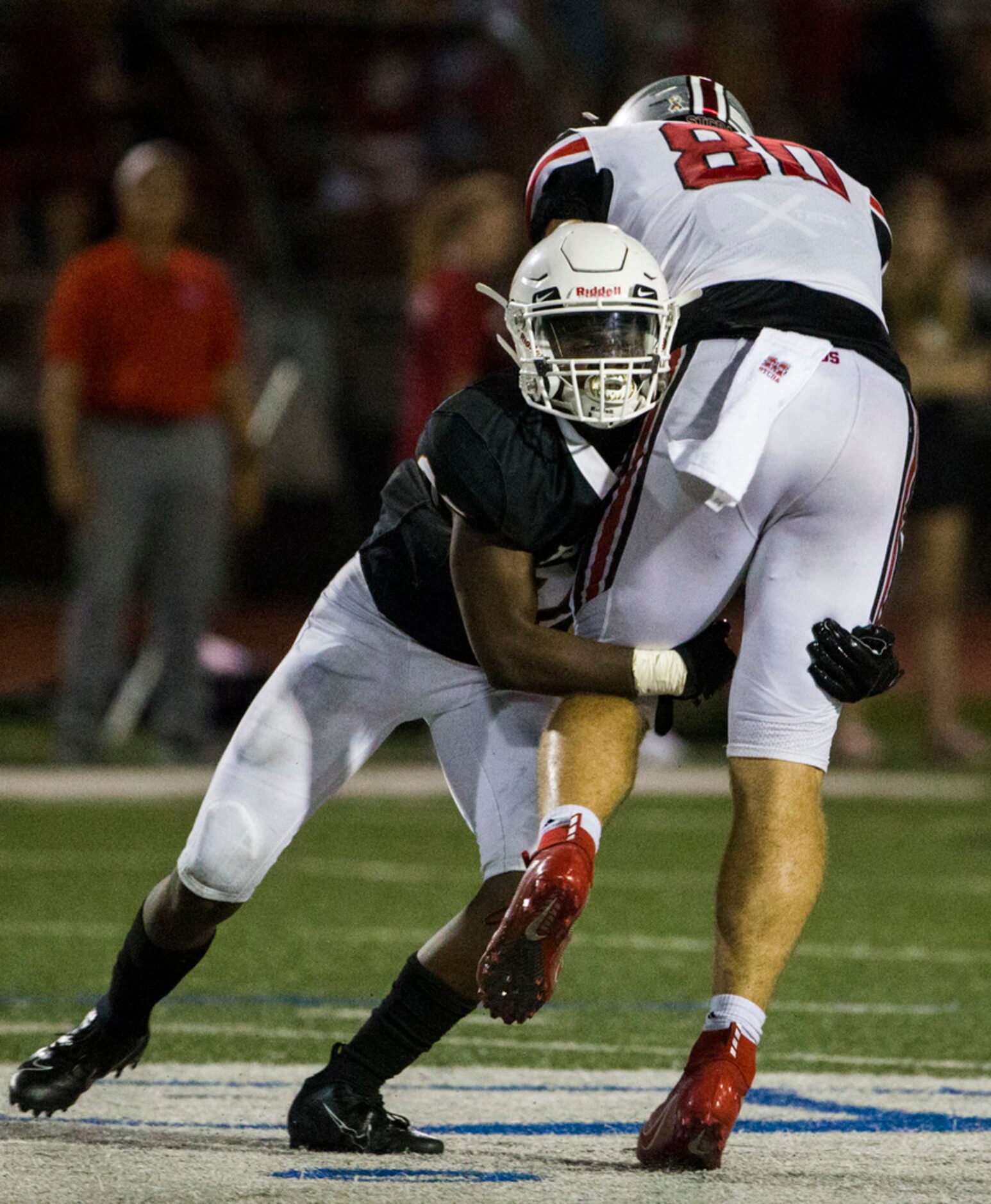 Arlington Bowie defensive back Tre Martin tackles Flower Mound Marcus's Collin Sutherland...