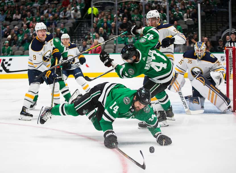 The Dallas Stars' Jamie Benn dives for the puck during the first period against the Buffalo...