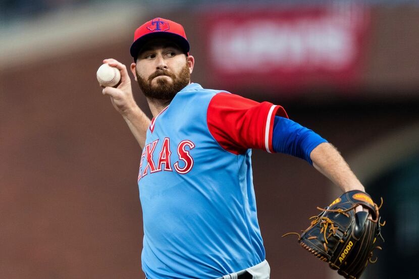 Texas Rangers starting pitcher Drew Hutchison throws to a San Francisco Giants batter during...
