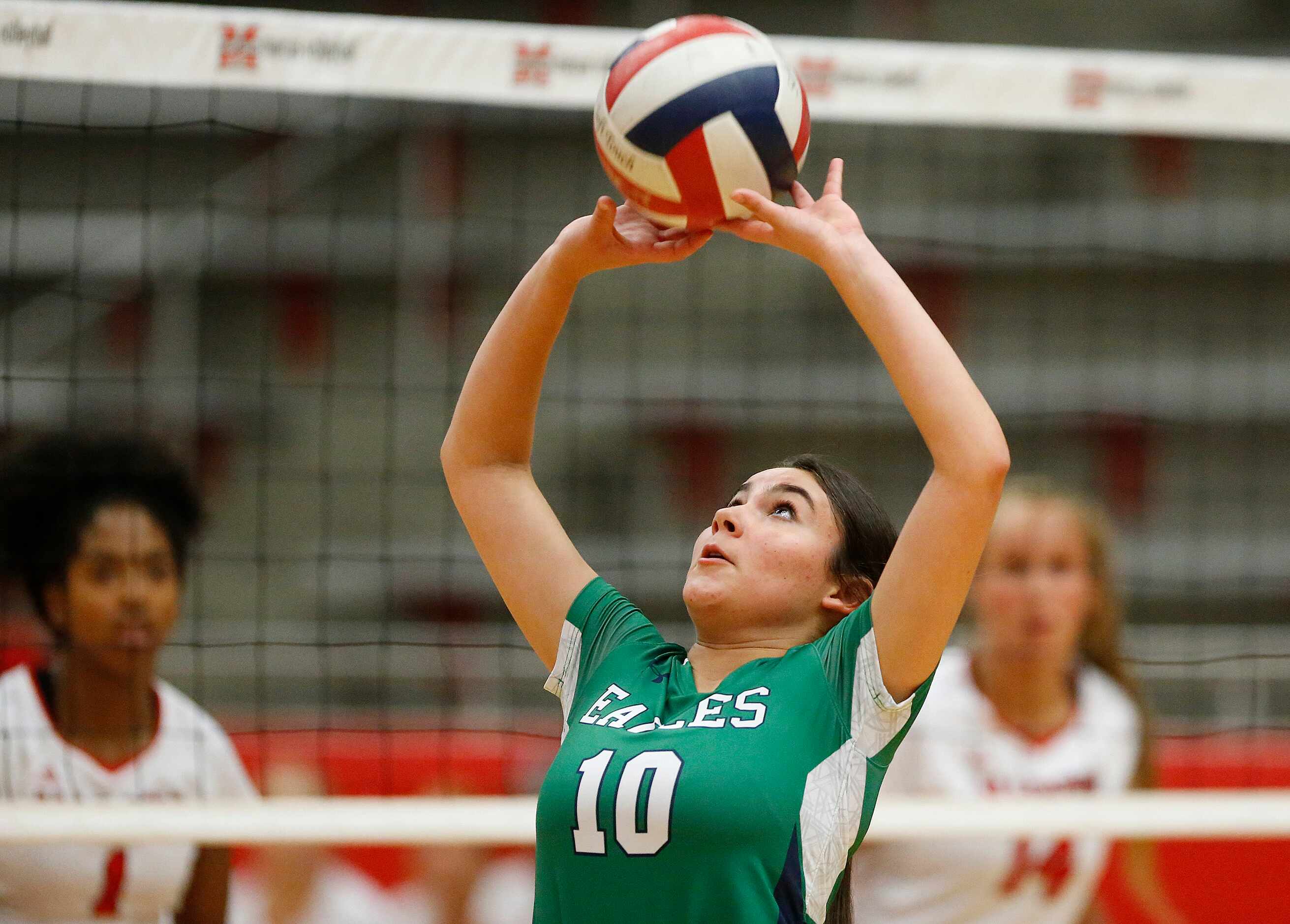 Eaton setter Lorena Gomez (10) makes a set in game one as Flower Mound Marcus High School...