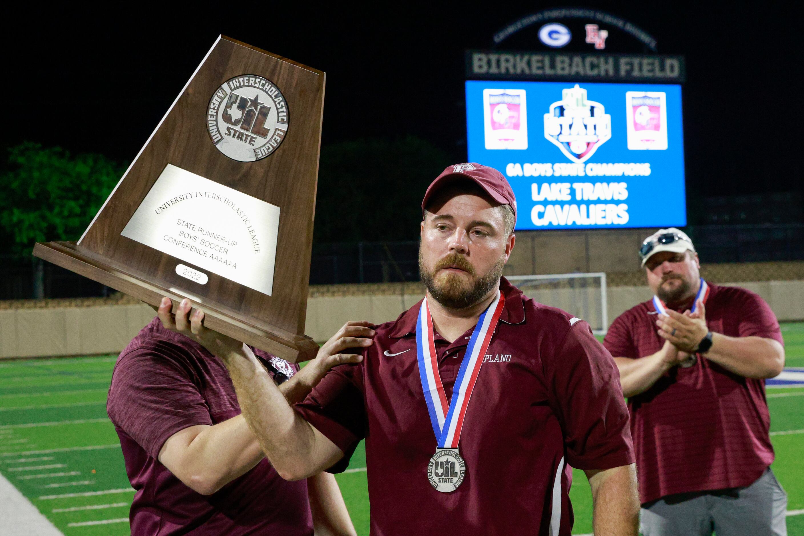 Plano head coach Tex McCullough raises during the Class 6A boys soccer state runner-up...