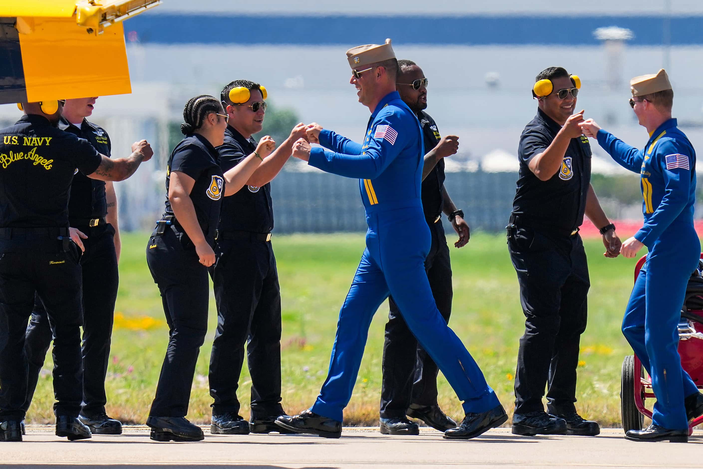 Cmdr. Alexander P. Armatas (center) fist bumps ground crew members as the Blue Angels...