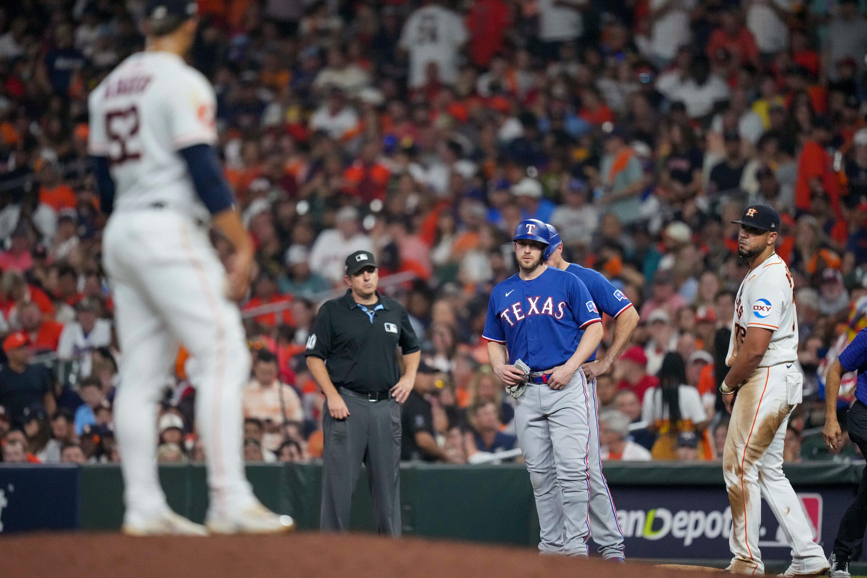 Texas Rangers designated hitter Mitch Garver (18) looks in the direction of Houston Astros...