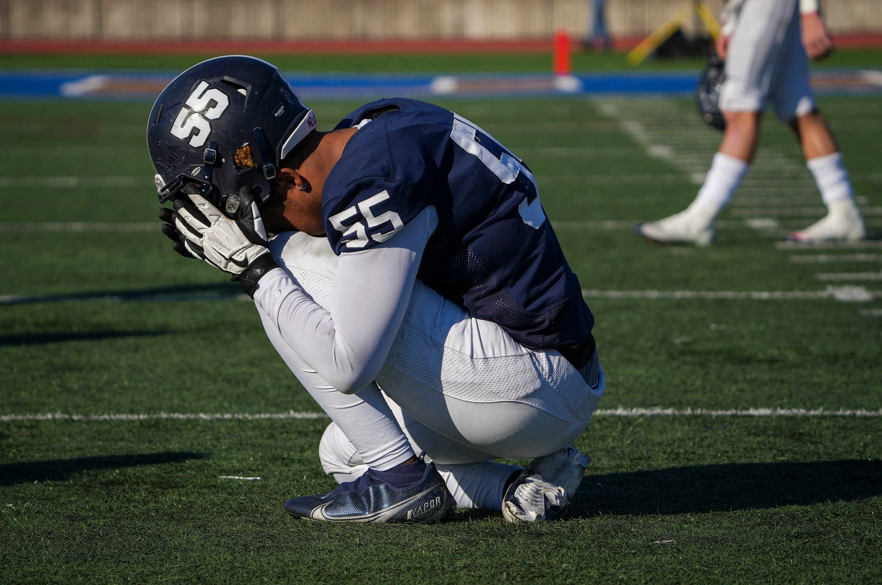 Episcopal School of Dallas defensive lineman Justin McCray (55) kneels on the field after a...